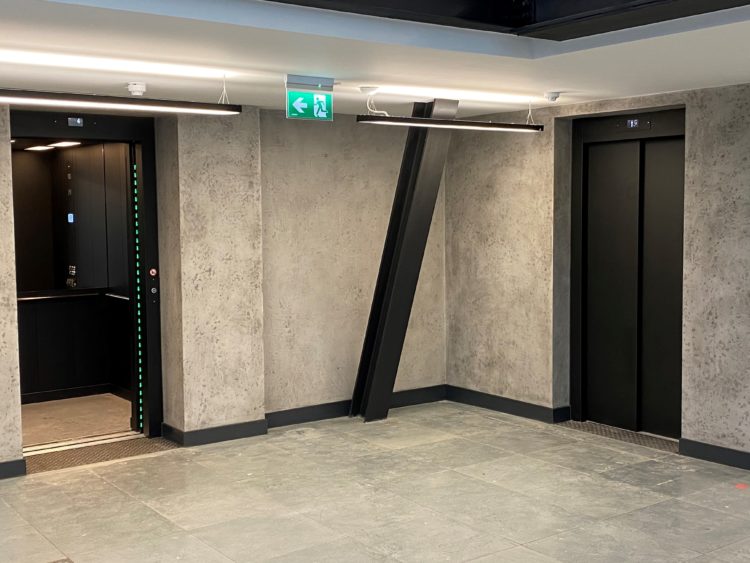 Grey & black interior reception area with newly installed lifts