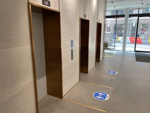A gold-trimmed lift with 5 meters makers on the floor