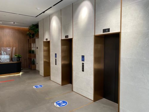 A gold-trimmed lift with 5 meters makers on the floor